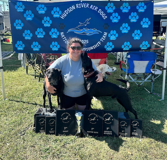 Emily Catignani with her dogs and competition awards